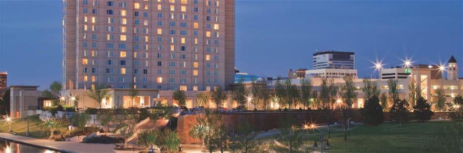 Image of Hyatt Regency Wichita and Convention Center by the river at dusk